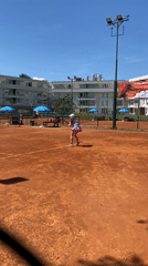 Young girl plays tennis on clay court in Montenegro