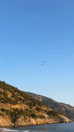 Paragliders land on Fethiye beaches during afternoon operations