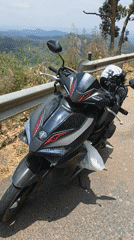 Motorcyclist stops on mountain road in Son Dien, Vietnam