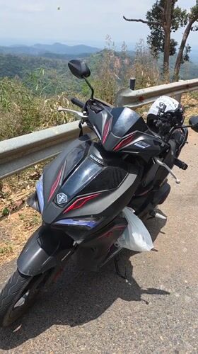 Motorcyclist stops on mountain road in Son Dien, Vietnam