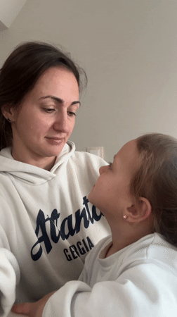 Mother and daughter share quiet moment at home in Varna