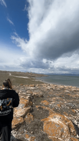 Visitors observe dramatic lakeside scenery in Berdkunk, Armenia
