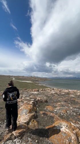 Visitors observe dramatic lakeside scenery in Berdkunk, Armenia