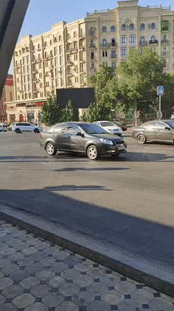 Street-level bus ride past Tashkent apartments and parked Golden Dragon