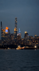 Nighttime city skyline view across water from Edgewater