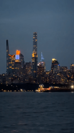 Nighttime city skyline view across water from Edgewater