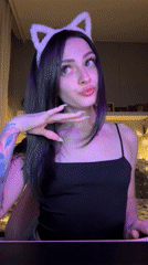 Woman takes selfies wearing cat ears in Reutov bedroom