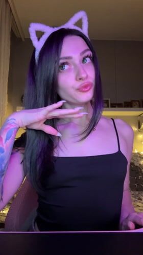Woman takes selfies wearing cat ears in Reutov bedroom