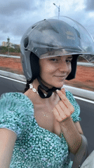 Woman in floral dress rides scooter in Mui Ne