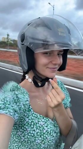 Woman in floral dress rides scooter in Mui Ne