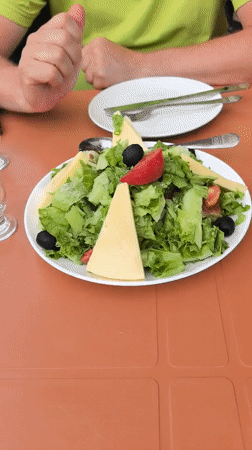 Outdoor café table in Batumi with salads and drinks
