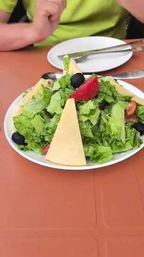 Outdoor café table in Batumi with salads and drinks