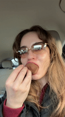 Woman enjoys chocolate strawberries in car in Moscow