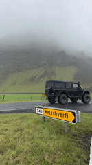Sheep graze in Icelandic countryside near Holtshverfi
