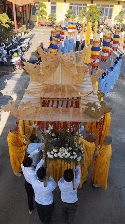 Buddhist procession with monks, palanquin held in Đà Lạt temple