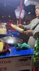 Night corn vendor serves street food in Puebla