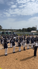 Marching band assembled in formation for outdoor ceremony, Nigeria