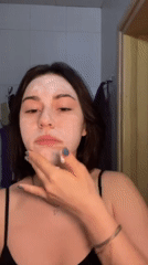 Woman documents morning skincare routine in Odesa bathroom