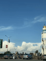 Normal traffic flows past clock tower in Kandahar
