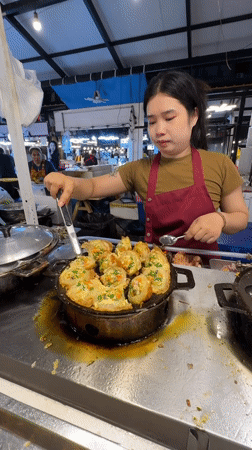 Street food vendors serve diverse dishes at Bangkok market