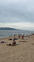 Nha Trang beachfront: swimmers, sand games, and promenade life