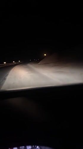 Night driving through snow-covered roads captured near Jdour, Morocco