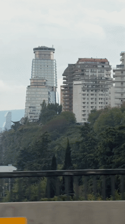 Overcast cityscape captured from Tbilisi bridge showing distinctive tower