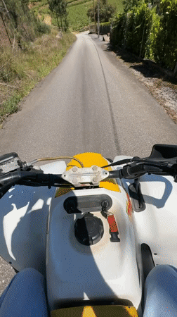 ATV rider travels rural road in northern Portugal
