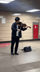 Violinist performs in Moscow subway station