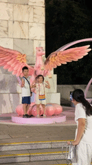 Peace signs and a pink unicorn statue in Nanshan District