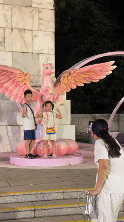 Peace signs and a pink unicorn statue in Nanshan District