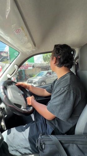 Man sits in driver's seat in Kuta Selatan
