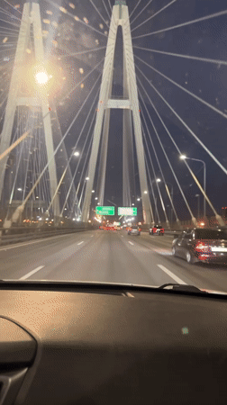 Nighttime traffic observed on cable bridge in Novosaratovka