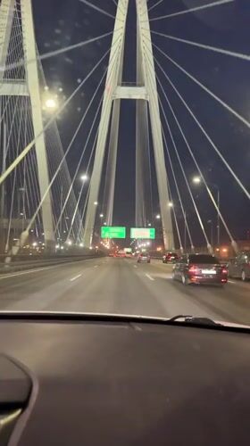Nighttime traffic observed on cable bridge in Novosaratovka