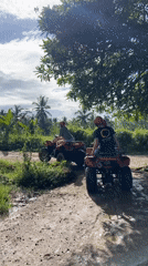 ATV riders navigate muddy Indonesian roads near midnight