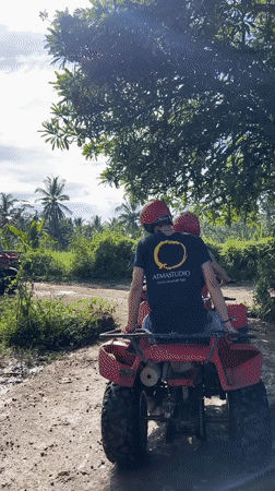 ATV riders navigate muddy Indonesian roads near midnight