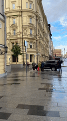 Rainy day street life documented around Moscow's Bolshoi Theatre