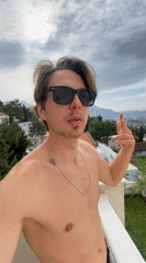 Man films selfie video on balcony in Šušanj, Montenegro