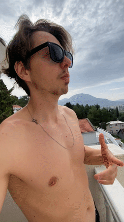 Man films selfie video on balcony in Šušanj, Montenegro