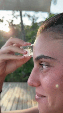 Person cools off with ice near flagged beach scene
