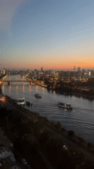 Moscow River at dusk, tour boats gliding under a sunset sky
