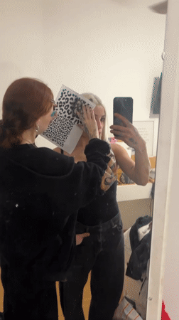 Women engage in creative stencil activity in Buenos Aires