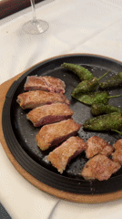 Cast-iron skillet of beef and green peppers, Madrid table