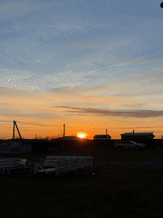 Woman documents sunset evening with child in Russian village