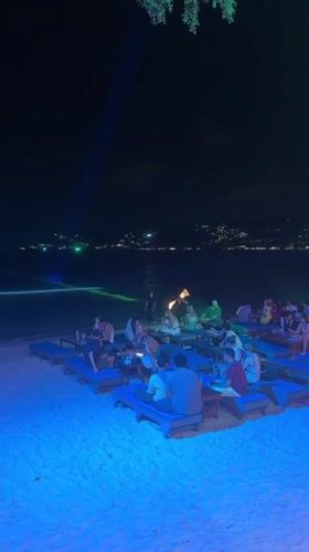 Nighttime beach dining scene captured in Ban Bang Rak