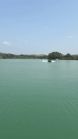Waterskiing on calm turquoise water near Rome