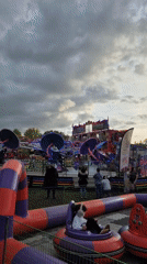 Amusement park visitors enjoy bumper cars and spinning rides in West Suffolk