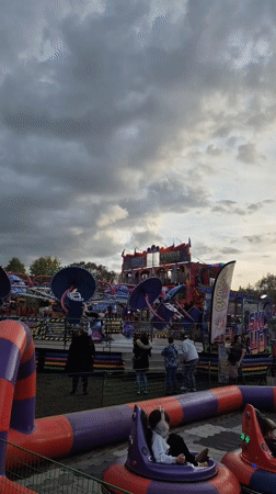 Amusement park visitors enjoy bumper cars and spinning rides in West Suffolk