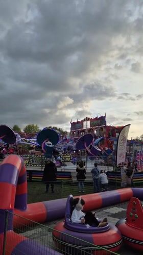 Amusement park visitors enjoy bumper cars and spinning rides in West Suffolk