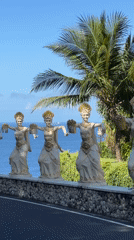 Motorcyclist encounters monkey near Balinese dance statues in Kuta Selatan